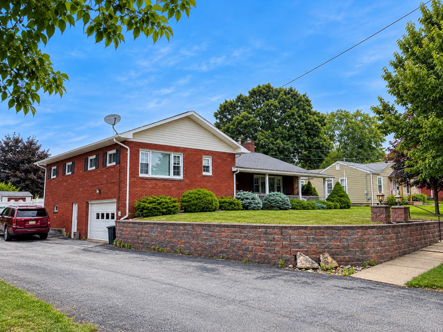 Exterior of the brick house at 317 Chestnut Street with its lawn and driveway