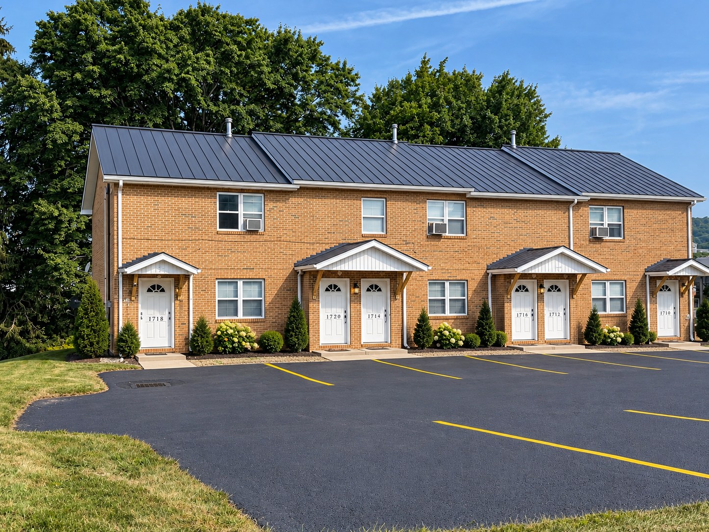 Exterior of the brick Getty Avenue apartment building and parking area